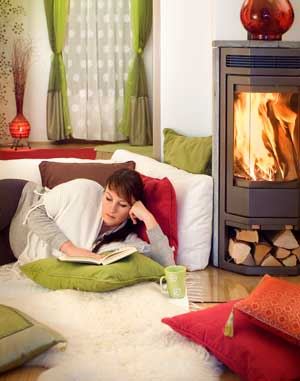 Women reading book by fireplace