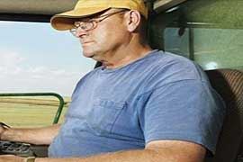 Man driving farm machinery